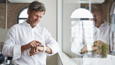 A man using a smartwatch in an office.