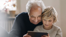 An adult and a child using a tablet together