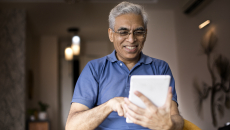 An older man using a tablet