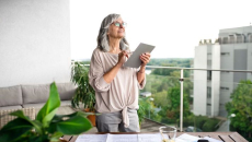 An older woman using a tablet.
