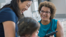 A parent and a child talking to a doctor