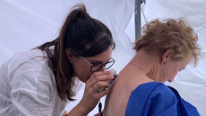 A doctor assessing a patient's skin