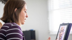 A woman talking to a provider using a tablet