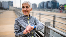 A person using a wearable while out on a run.