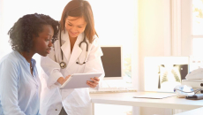 Healthcare provider showing someone a tablet