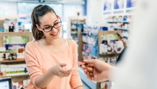 Person at a pharmacy interacting with a healthcare provider