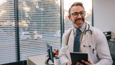 Doctor standing in a room and smiling