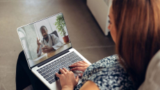 Person on a computer speaking with a healthcare provider