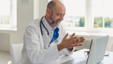 Healthcare provider on their computer speaking with someone