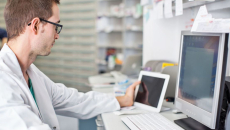 Healthcare provider looking at two computers