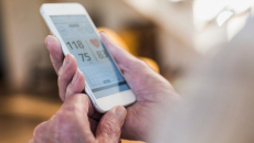 A user checks their vitals from a mobile health app
