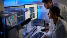 Healthcare providers sitting down and looking at a computer