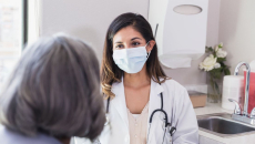 A doctor consulting with an elderly patient