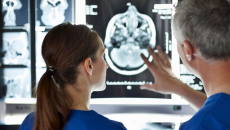 Surgeons analysing a brain scan.