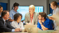 Healthcare and business professionals in an in-person conference meeting