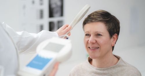 A doctor measuring a patient's intracranial pressure using an implantable sensor