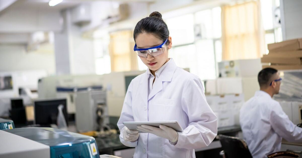 A laboratory scientist using a digital tablet