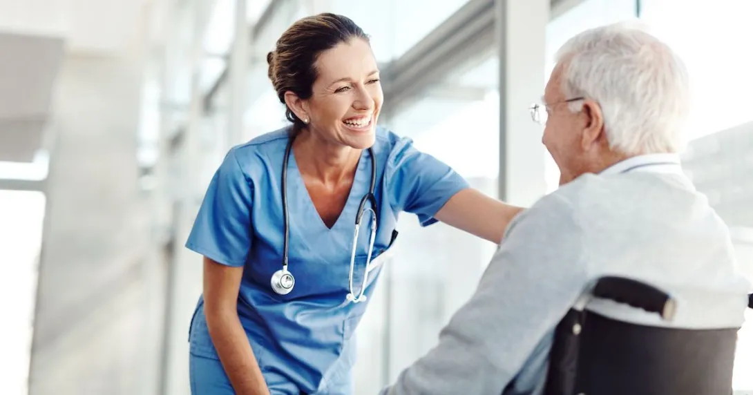Person in a wheelchair next to a nurse
Person in a wheelchair next to a nurse