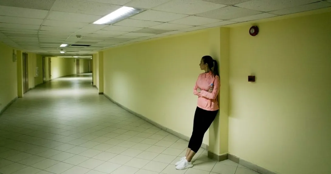 Person standing in the hall of a halfway house
Person standing in the hall of a halfway house