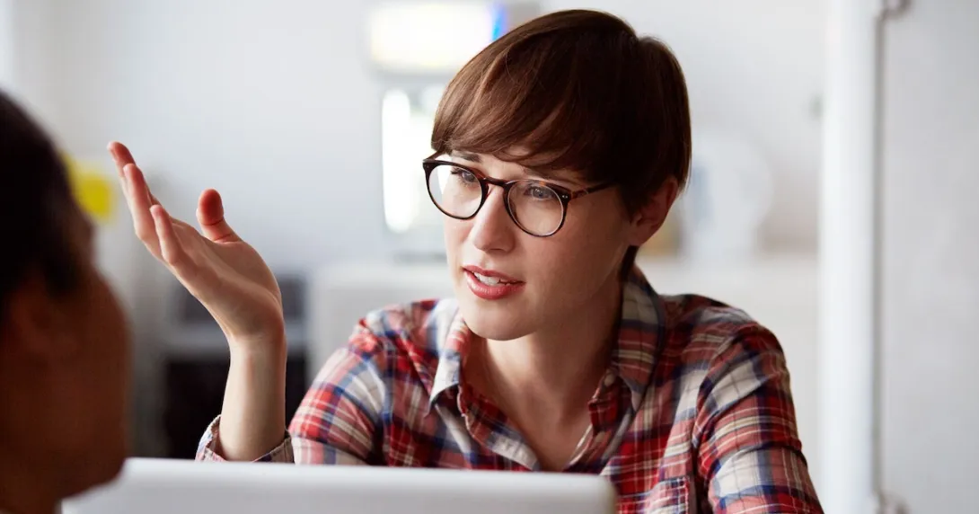 Person on a laptop speaking with someone and wearing glasses
Person on a laptop speaking with someone and wearing glasses