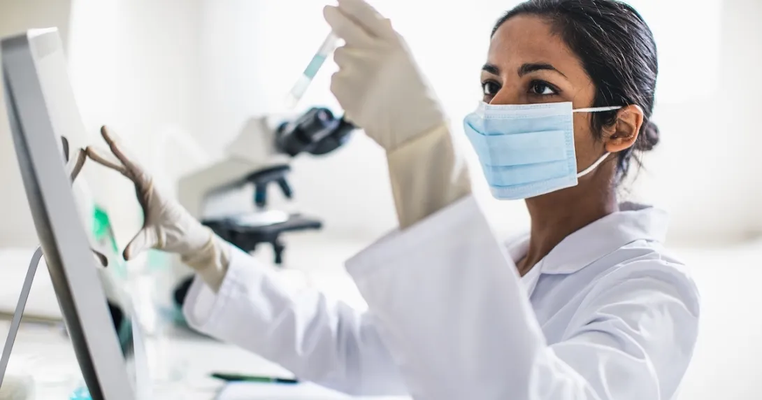Technician analyzing the content of a test tube