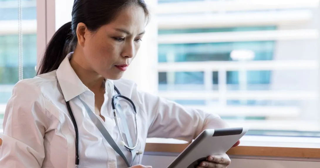 Healthcare provider looking at a tablet
