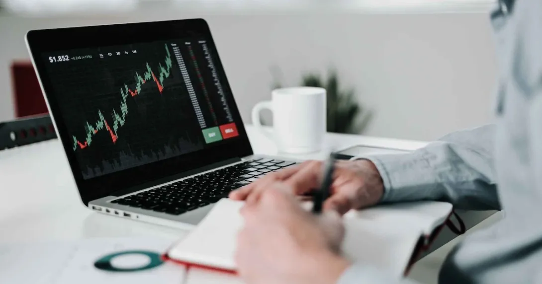 Young businessman using laptop for analyzing data stock market