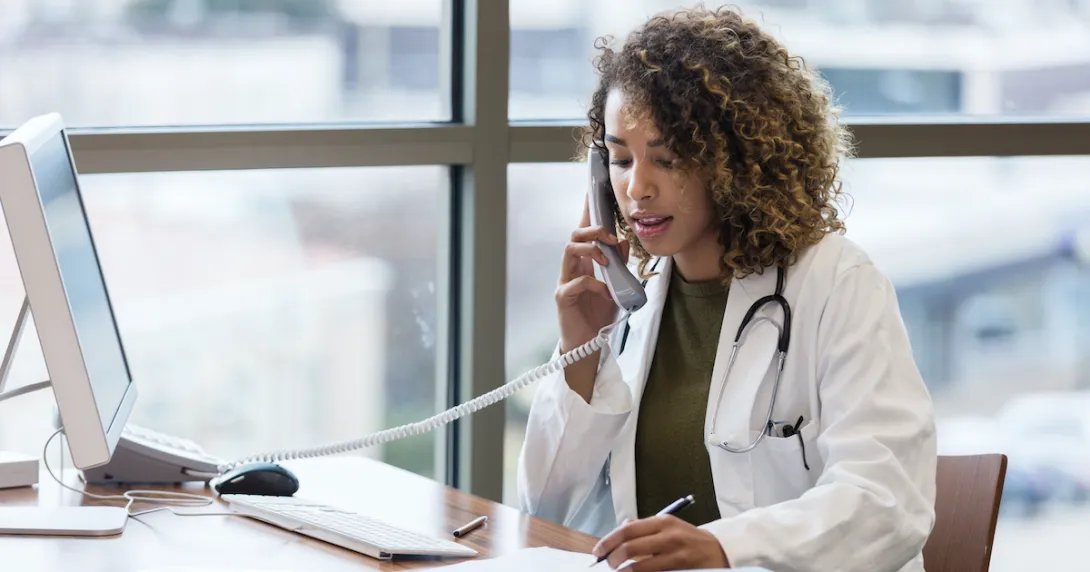 A doctor on the telephone, consulting