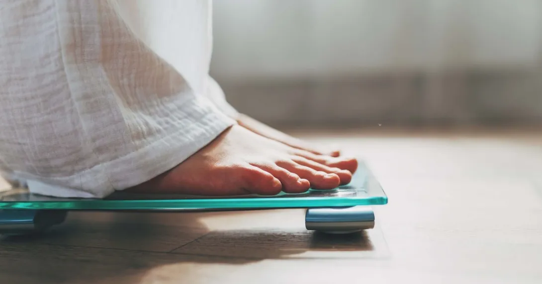 Person's feet while they are standing on a scale