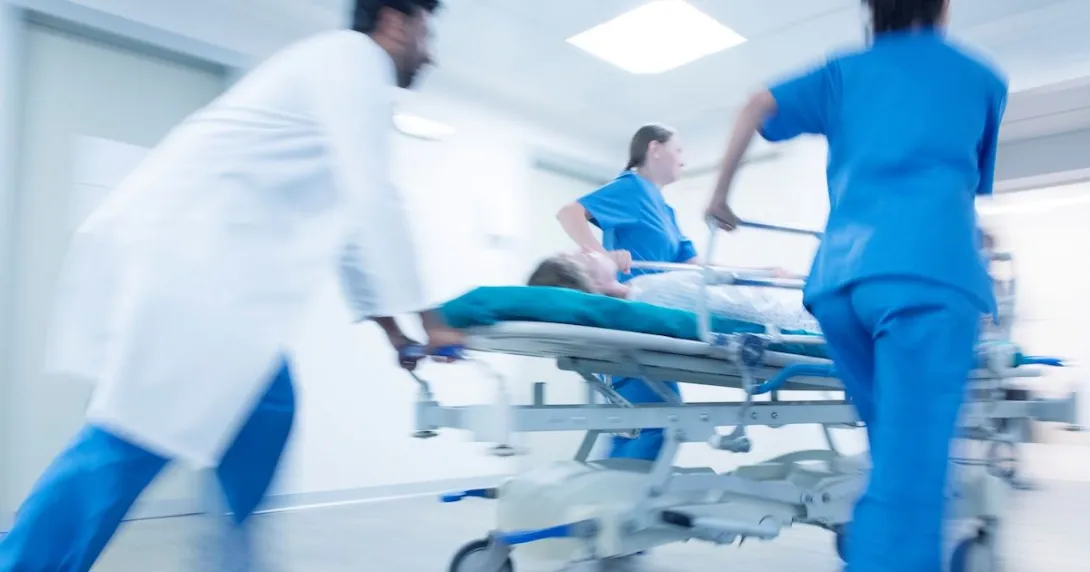 Emergency staff transporting a patient on a gurney