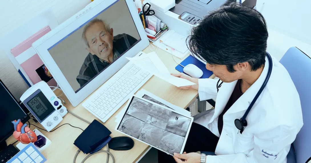A doctor explaining a patient's heart X-ray findings via video call