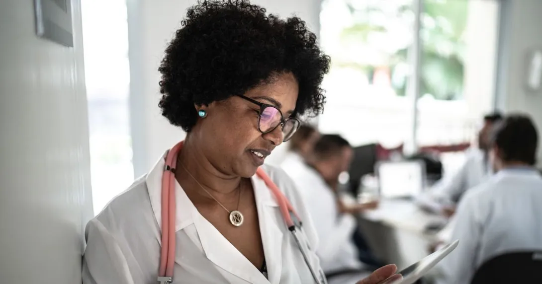 Healthcare provider on a tablet in a clinic