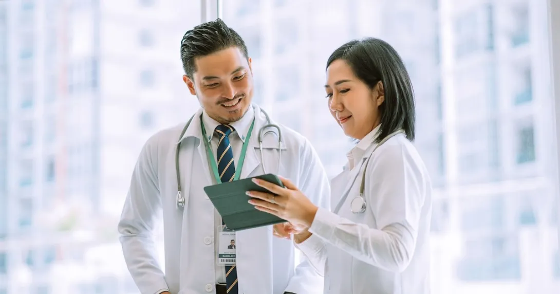 Doctors reviewing a patient file on a digital tablet