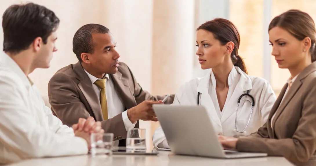 Doctors and businesspeople meeting in a room
