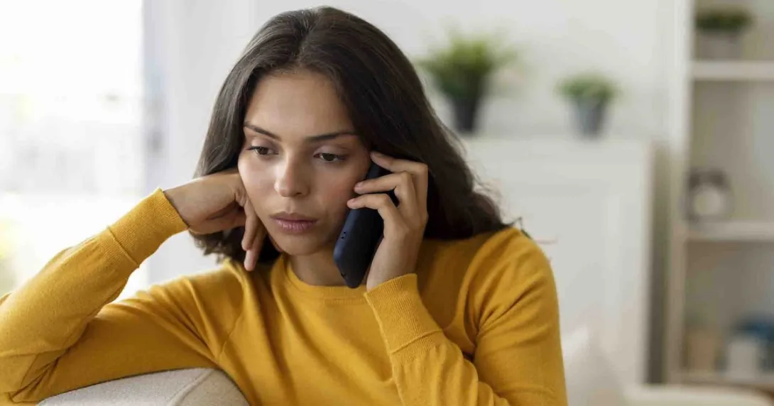 Person on the phone who looks concerned