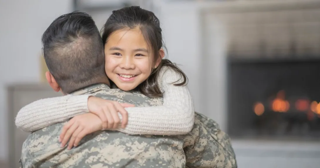 Military person hugging another person