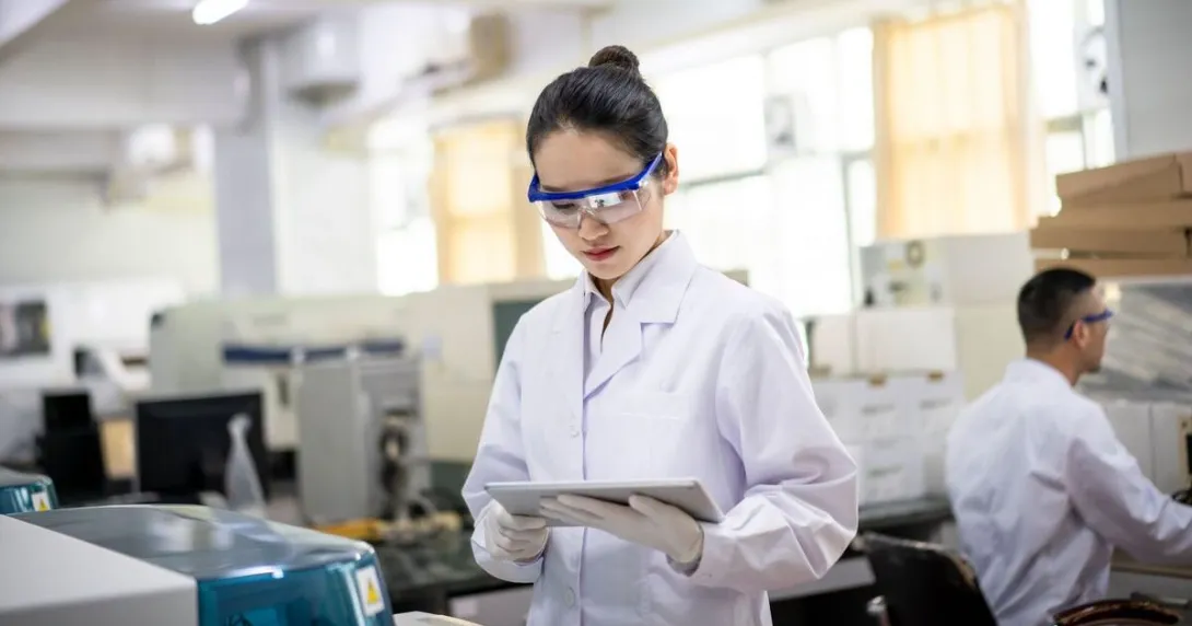 A laboratory scientist using a digital tablet