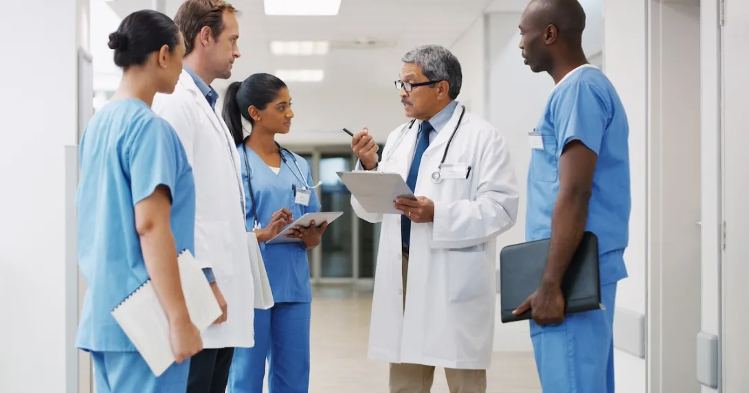 Health care clinician consulting with staff