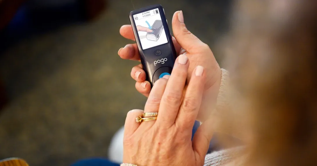 A close up of a woman using the POGO system