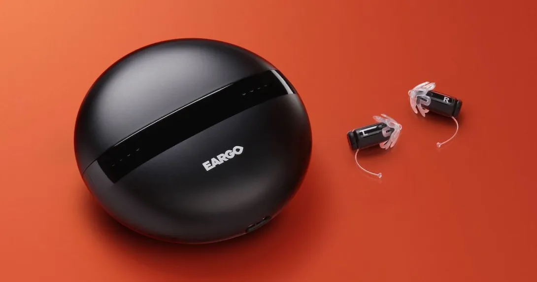 Eargo hearing devices and carrying case on an orange background
