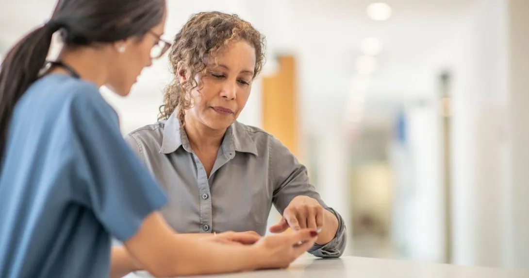 A healthcare provider and another person looking at something