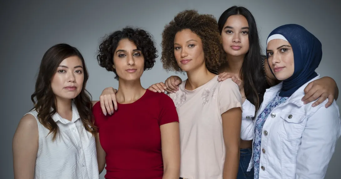 Five people standing by each other