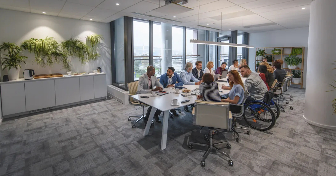 Numerous people sitting around a table