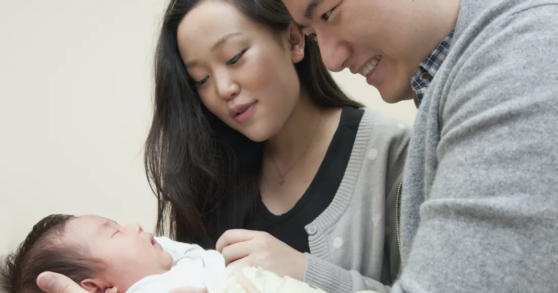 Parents holding their newborn child