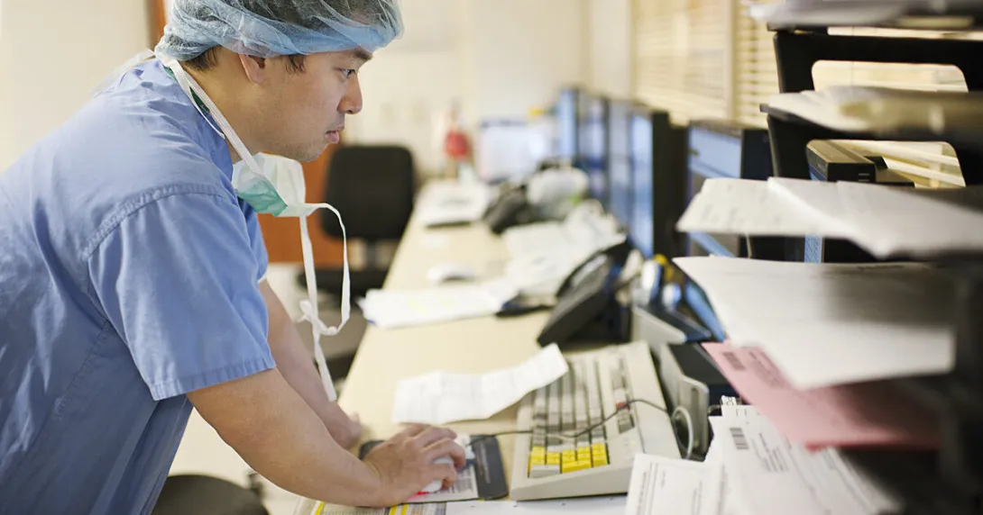 A doctor using a desktop computer
