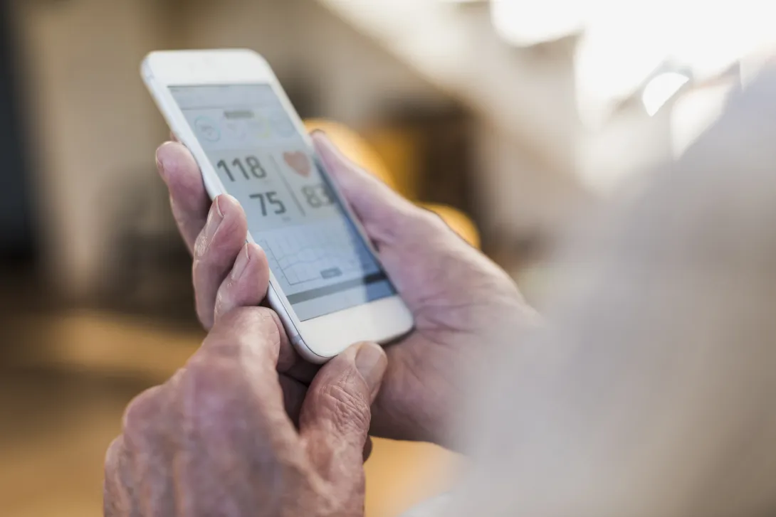 A close-up image of a person using a digital health app on a smartphone.