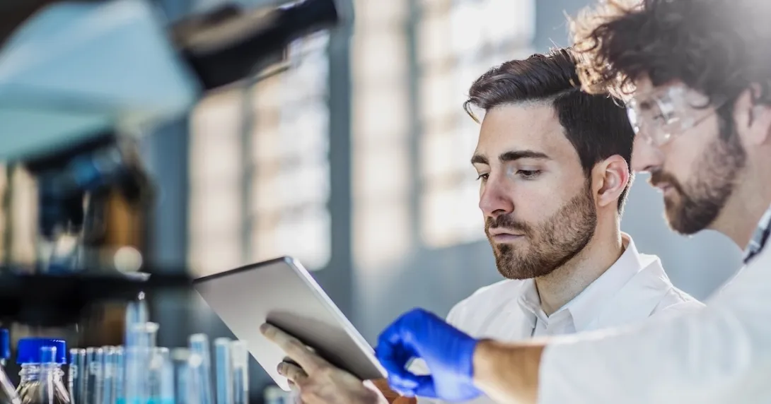 Two healthcare professionals looking at a tablet
