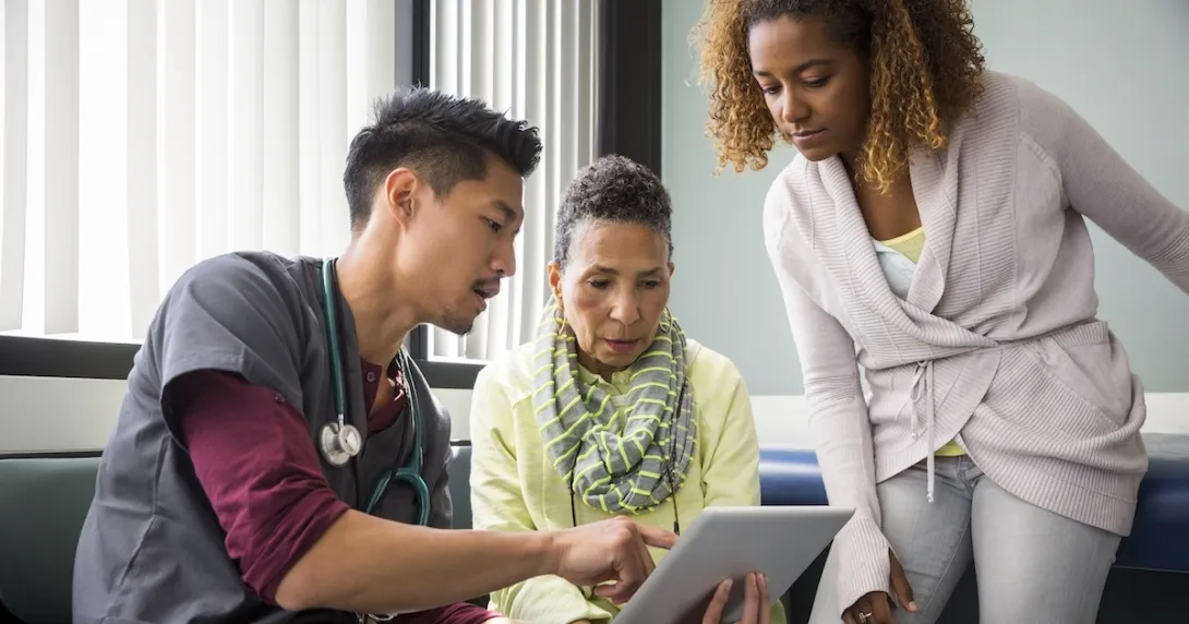 Healthcare provider consulting with a patient and family member