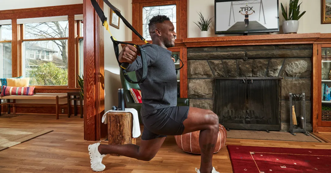 employee working out at home with the TRX for Employee Wellbeing program