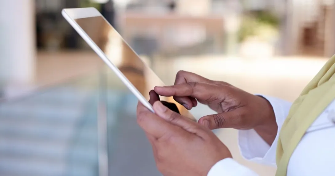 A close up of a person holding a tablet